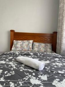a bed with a white towel laying on it at Alpha homes in Gatunga +55 photos