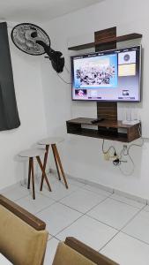 ジョアンペソアにあるApartamento mobiliado em João Pessoaのリビングルーム(テレビ、テーブル、ランプ付)