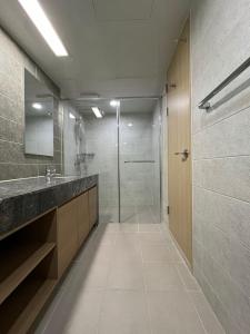 a bathroom with a shower and a sink and a mirror at FreeLuggageStorage 1Queen1SingleBed MilkyWay in Pyeongchang  +16 photos
