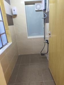 a bathroom with a shower with a window and a door at De Cameron Guest House in Tanah Rata +15 photos