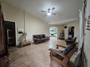 a living room with couches and a ceiling fan at Finca Don Celestino in La Banda
