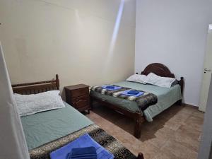 a bedroom with two beds and a table in it at Finca Don Celestino in La Banda +19 photos