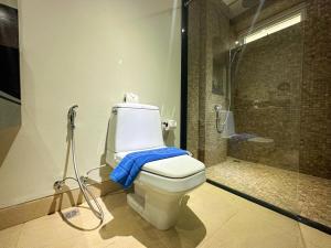 a bathroom with a toilet with a blue towel on it at NEW Malee Resort Studio 858 in Rawai Beach +25 photos