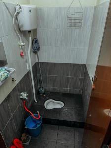 a small bathroom with a toilet in a stall at Izzah homestay pcb in Kota Bharu
