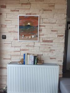 a brick wall with a radiator with books on it at teo`s Apartment Nikiti in Nikiti