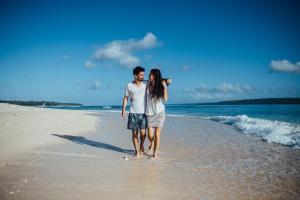 a man and a woman walking on the beach at Dany Island in Luganville +16 photos