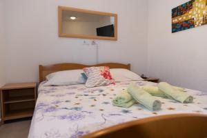 a bed with pillows on it in a bedroom at Apartments Kastilac near the beach in Kaštela +53 photos