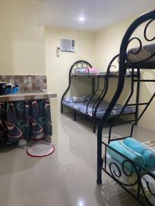 a room with two bunk beds in a room at Leonisa Transient House in Mariveles