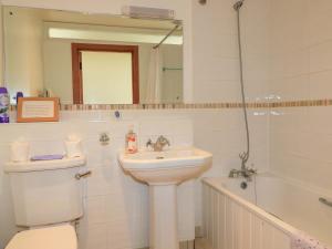 a bathroom with a sink and a toilet and a tub at The Old Cart Shed in Blandford Forum +20 photos