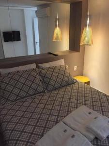 a bedroom with a bed with two pillows and a mirror at Malawi Resort Essence in Porto De Galinhas +17 photos
