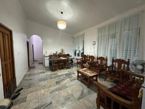a living room with chairs and a dining room at Sea LaVie Guesthouse in Siquijor