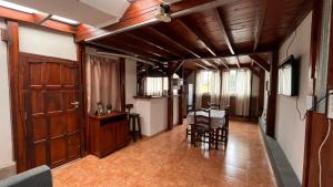 a hallway with a table and chairs in a house at Cabaña Norte Loft in San Miguel de Tucumán