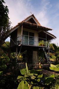 a house with a thatched roof at Royal mountain lake view in Ratchaburi