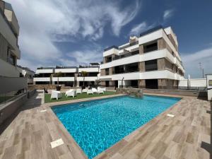 a building with a swimming pool in front of a building at Holidoo Travel "Casa Maru" in San Javier