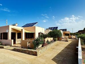 a house with solar panels on top of it at Rousolakos Pool Apartments in Palekastron