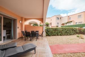 a patio with a table and chairs in a house at LE MUSE Residence - Punta Tegge in La Maddalena