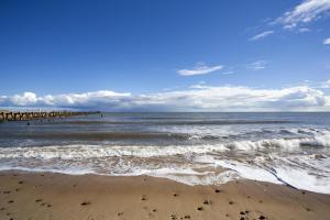 a view of the beach with a pier in the water at Spacious 8 Berth Caravan At Dovercourt Holiday Park, Essex Ref 44202K in Great Oakley