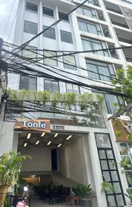 a building with a sign on the front of it at Tonle Hostel in Phnom Penh