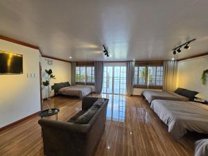 a large living room with two beds and a couch at Simoy Staycation Tagaytay in Tagaytay