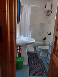 a bathroom with a sink and a toilet at Villalba in Cala Liberotto +29 photos