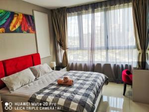 a bedroom with a bed with a teddy bear on it at Happy Holiday,I-Soho, I-City, Shah Alam ,Free Wifi & Parking in Shah Alam +42 photos