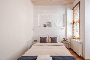 a white bedroom with a bed and a brick wall at Private House Istanbul OldCity in Istanbul