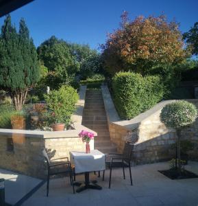 a table and chairs with a table and a staircase at Chambre d'hôtes de Marie in Chémery +8 photos