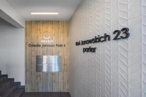 a lobby of a building with a sign on a wall at Apartament przy Błoniach in Rumia