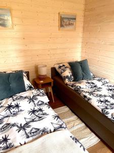 pokój z dwoma łóżkami i stołem w obiekcie Holiday Resort Zakątek Łeba w Łebie +6 zdjęć
