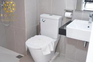 a bathroom with a white toilet and a sink at Royal Suites Studio 6ZR - Kaina Tower at Nuvasa Bay in Pulau Nongsa