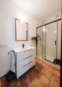 a bathroom with a sink and a shower at Cases Tonet Apartamento-loft in Forcall