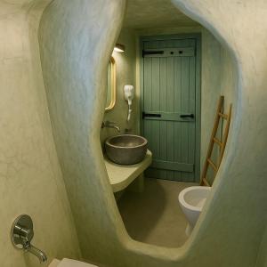 a bathroom with a bowl sink and a toilet at Selora Cave in Pirgos +8 photos