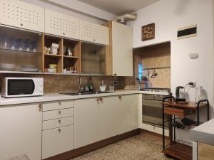 a kitchen with white cabinets and a microwave at Ca Donzela in Venice