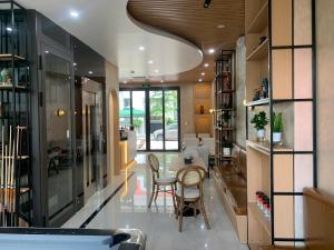 a kitchen with a table and chairs in a room at Sunny Hotel in Ðố Sơn