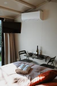 a bedroom with a bed with two pillows on it at Badhuisje aan Zee op Huisduinen in Huisduinen