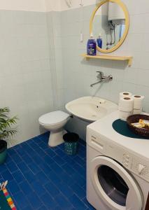 a bathroom with a toilet and a washing machine at Vila Zorka in Trebinje +20 photos