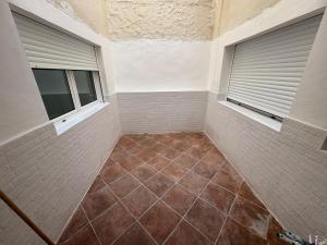 a walk in shower with a window and a tiled floor at apartamento san urbano in Almería