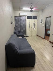 a room with a bed and two chairs in it at AA Homestay in Pengkalan Cepa