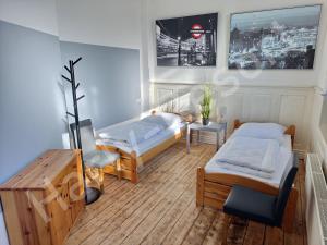 a room with two beds and a table at Harly-Resort in Goslar