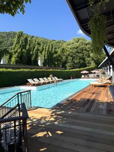 a large swimming pool with lounge chairs and trees at Sunset Beach Hotel - Adults Only in Haad Rin