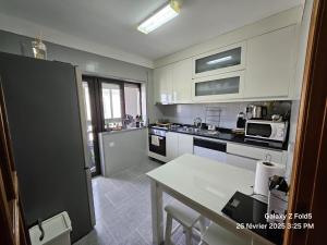 a kitchen with a table and a counter top at Ocean's view in Árvore