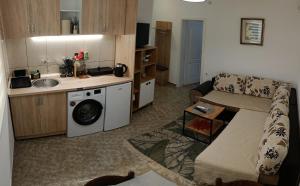 a living room with a couch and a washing machine at TEA7 apartment in Kotor