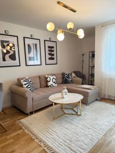 a living room with a couch and a table at Cozy Flat near Airport & Sarajevo Center, Free Parking in Sarajevo