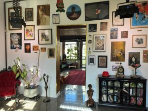 a living room with a wall of pictures on the wall at otto7senses in Haifa