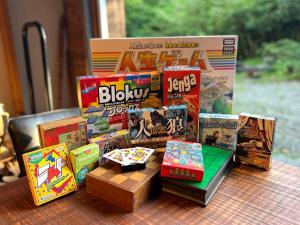a pile of games on a table with a box at The Suite Forest FUKUOKA DAZAIFU -TOBARI- 1日1組限定の貸別荘 大型犬ペット可 in Dazaifu