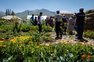 a group of people standing in a garden at Hidden Valley Guesthouse in Toguz-Bulak