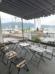 a group of tables and chairs under an umbrella at Rami Xanh Stay in Danang