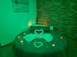 a bedroom with a bed with a heart made out of lights at Nuit Blanche Normandie in Eu