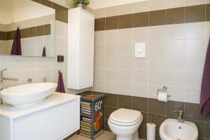 a bathroom with a sink and a toilet at Appartamento Gassman - Holiday Apartment in Milano in Milan +22 photos
