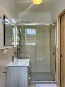 un bagno con doccia e lavandino di Rooms del Moro a Patù